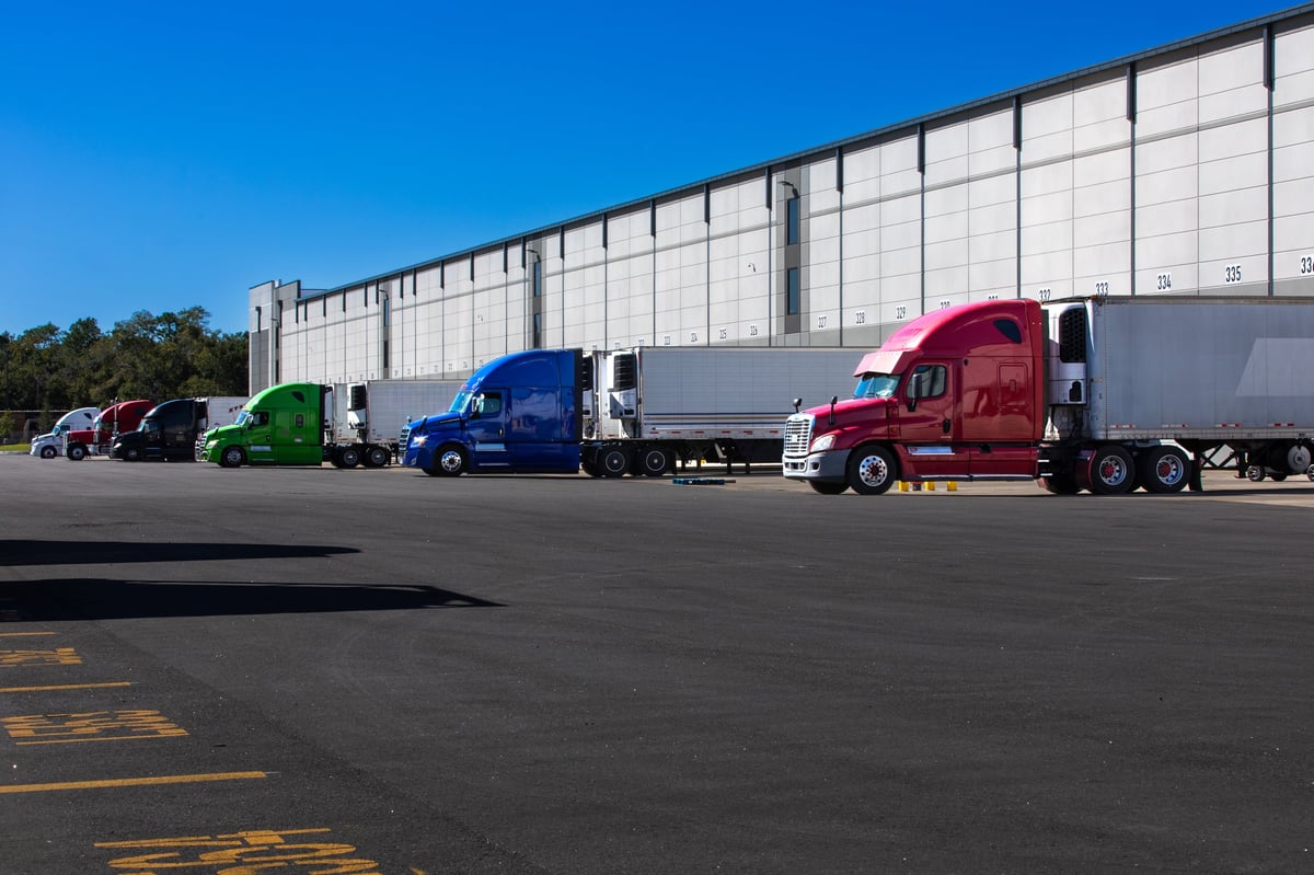 Semi trucks parked at warehouse loading docks